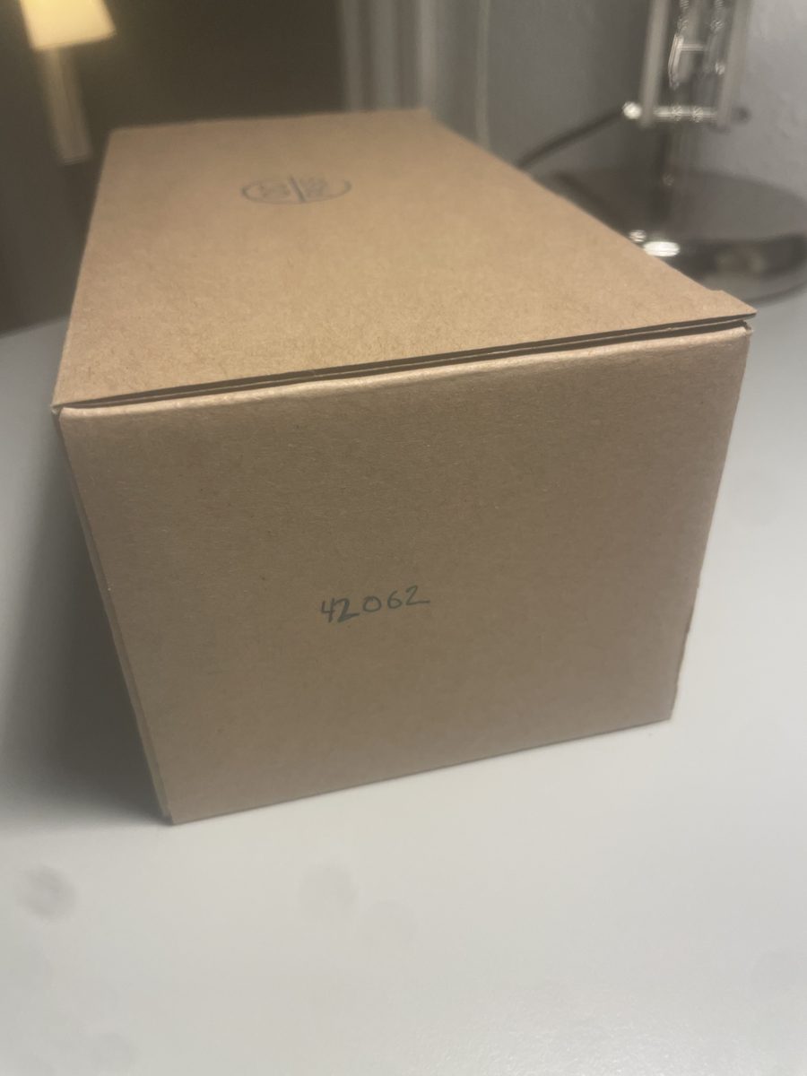 A closed cardboard box with a set number written on the side