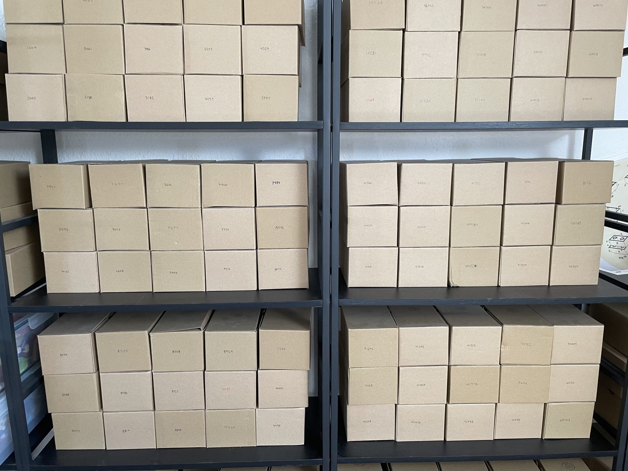 Metal shelving filled with rows of identical small cardboard boxes