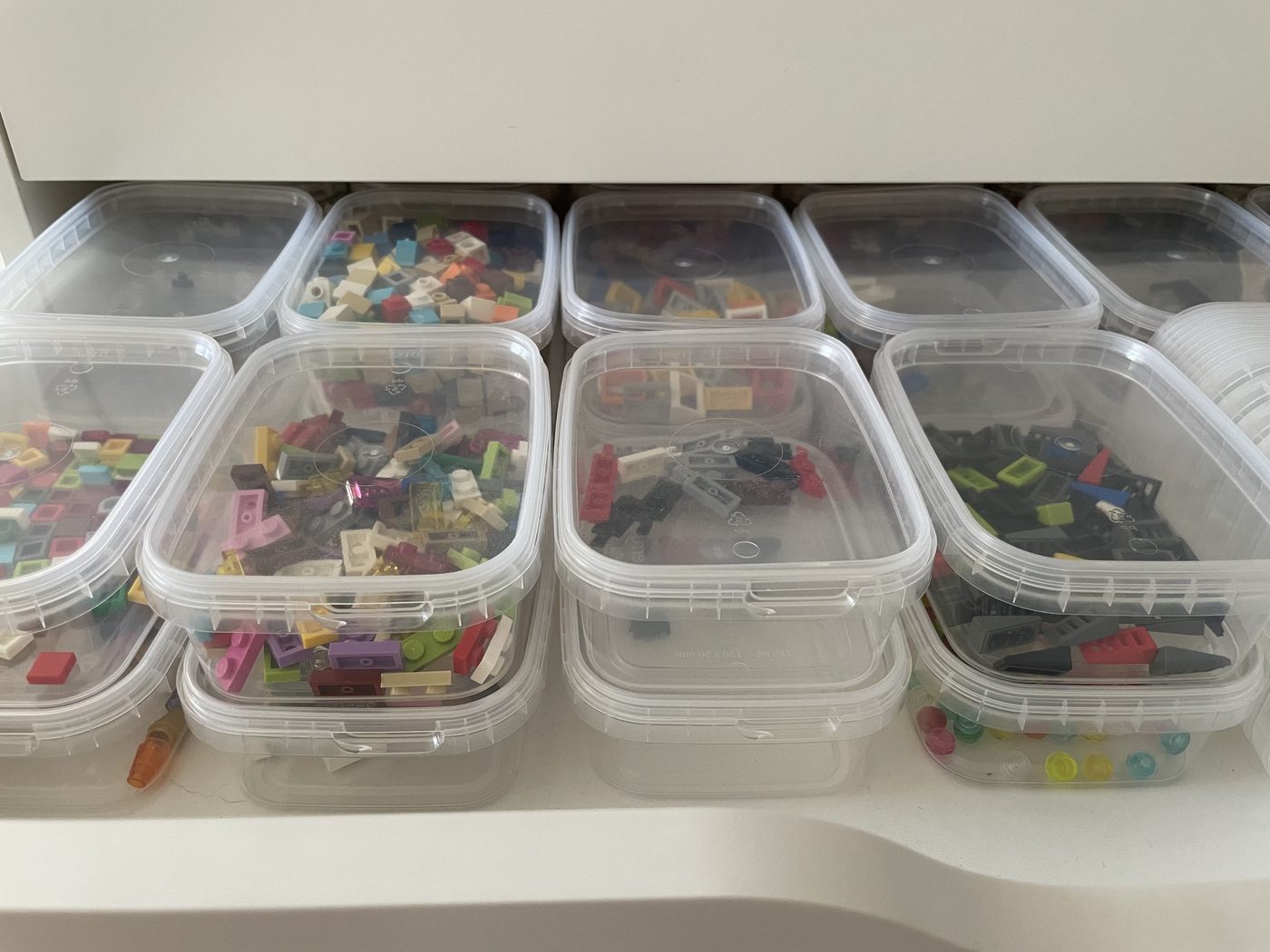 A drawer of small clear tubs, each holding one kind of small part
